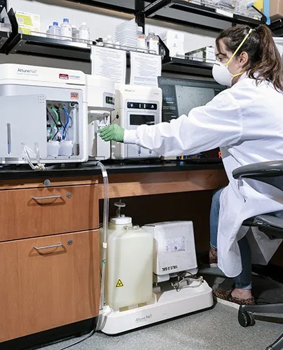 A researcher at the Attune NxT flow cytometer